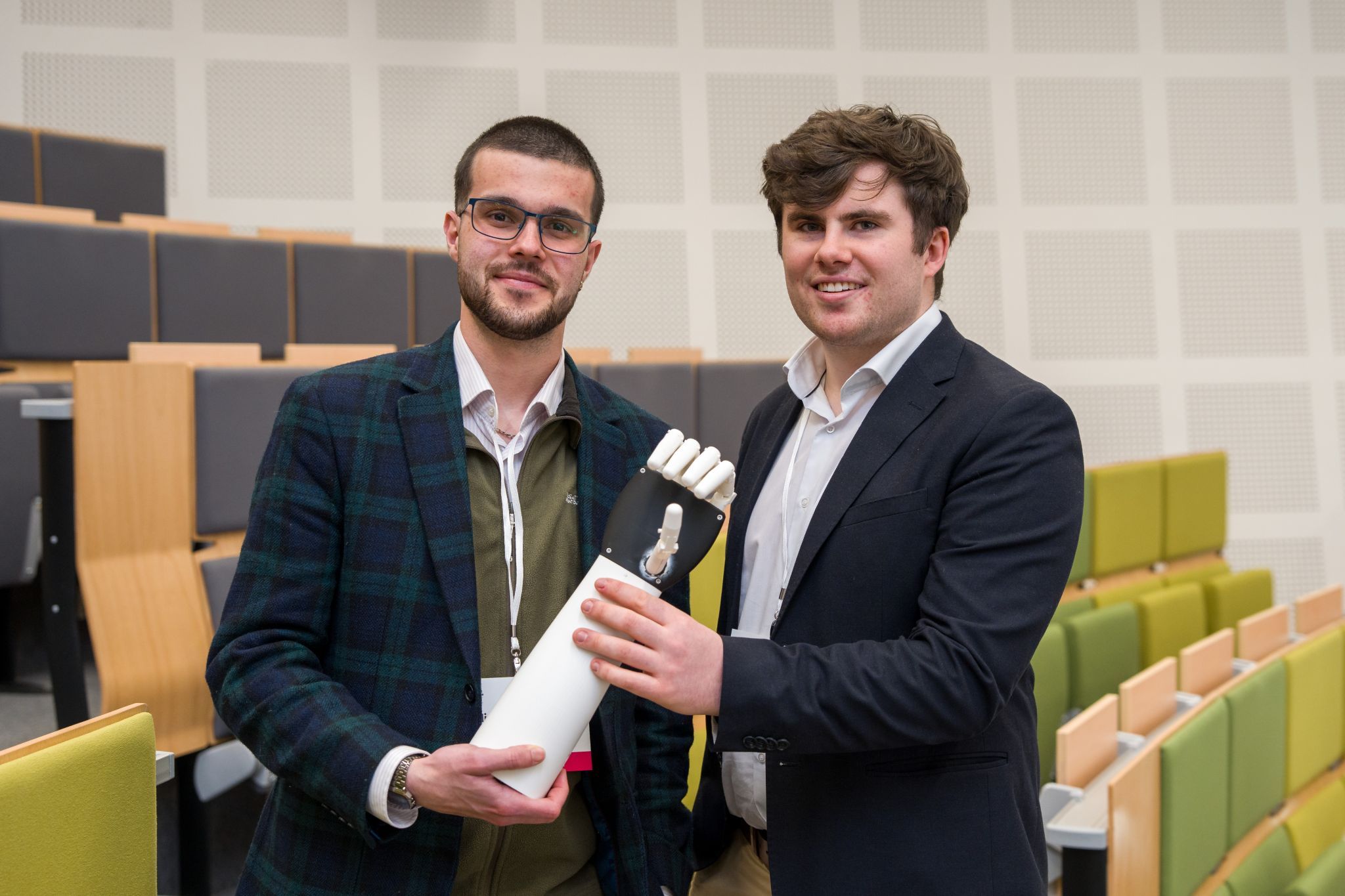 William Hartley and Sean Barrett holding the ReAble prosthetic hand at the Hult Prize Irish National Final at UCD