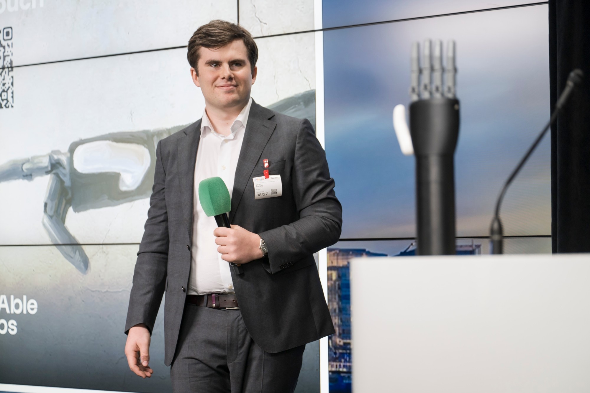 Sean Barrett on stage at Google with the Diego hand on the lectern, during the Hult Prize Global Accelerator, August 2026.