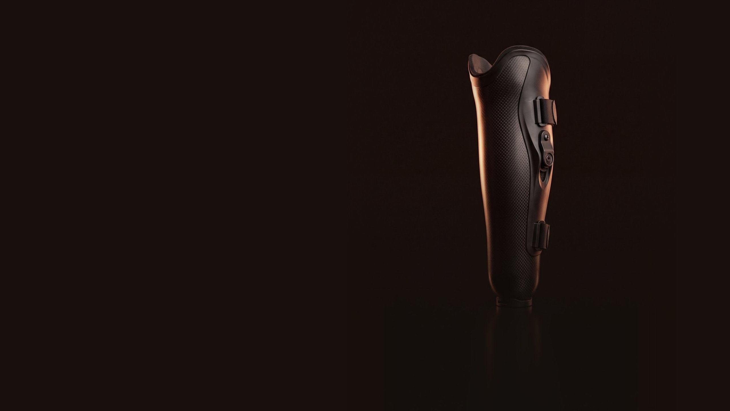 A socket made in ReMould, black, standing on a dark stage. Render.